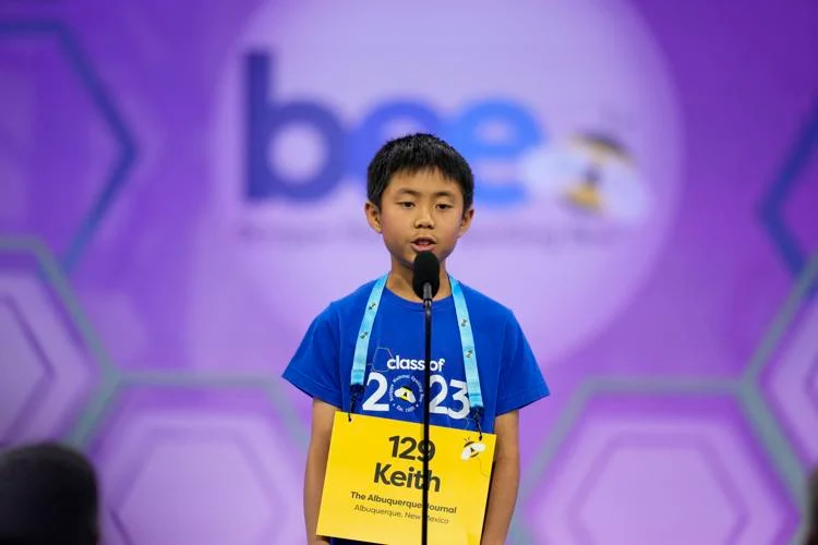 Boy participating in spelling bee competition.